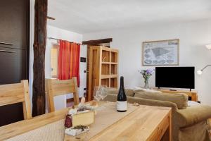 a living room with a couch and a table at Maison Gnemaz Grand Combin in Aosta