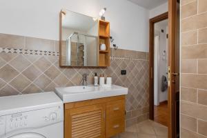a bathroom with a sink and a washing machine at Maison Gnemaz Grand Combin in Aosta +28 photos