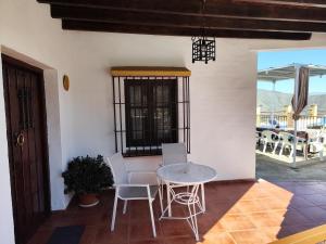 a room with a table and chairs and a patio at Casa Villazo 2 in Málaga +15 photos