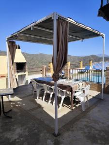a table and chairs under a canopy on a patio at Casa Villazo 2 in Málaga