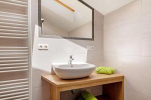 a bathroom with a sink and a mirror at Forchnerhof Apt Rose in Maranza +27 photos