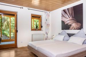 a bedroom with a bed and a window at Landhaus Echerschwang in Bernbeuren