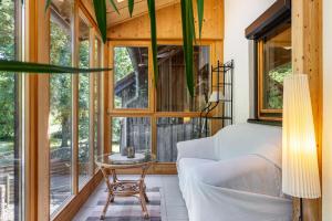 a room with a bed and a table and windows at Landhaus Echerschwang in Bernbeuren
