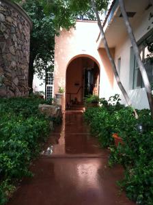an entry to a house in the rain at Lundeen Inn of the Arts in Las Cruces