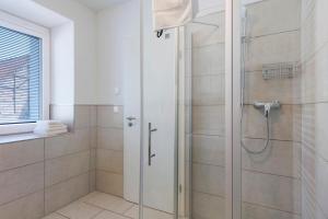 a shower with a glass door in a bathroom at Torhaus Schloss Wocklum in Balve +54 photos