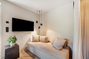 a living room with a couch and a flat screen tv at Casa Sonngart in Parcines