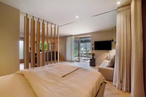 a bedroom with a large bed and a couch at Casa Sonngart in Parcines +20 photos
