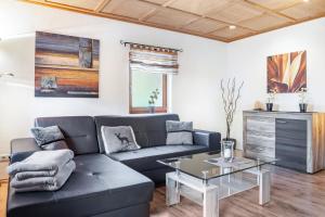 a living room with a couch and a table at Landhaus Echerschwang in Bernbeuren