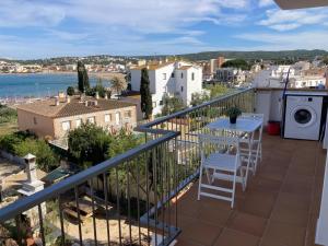 a balcony with a table and a washing machine at Apartamento ático en L'Escala in L'Escala