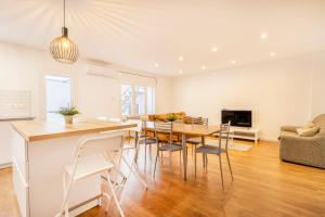 a dining room and living room with a table and chairs at Casa Olegari in Almacellas +17 photos