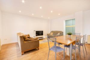 a living room with a table and chairs and a television at Casa Olegari in Almacellas