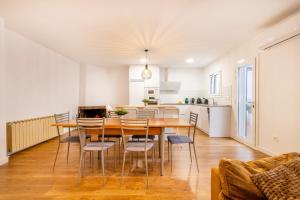 a kitchen and dining room with a wooden table and chairs at Casa Olegari in Almacellas