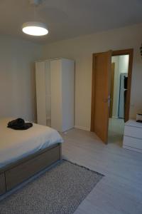 a bedroom with a bed and a closet and a door at Kaiju Apartment 15 in Liepāja