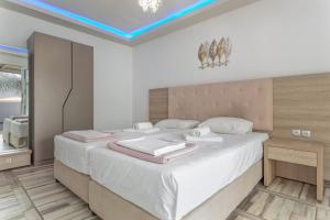 a bedroom with a large bed with white sheets at Villa Dionysia Studio S2 in Alikanas +18 photos