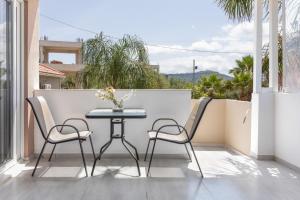 a patio with a table and chairs on a balcony at Villa Dionysia Studio S2 in Alikanas