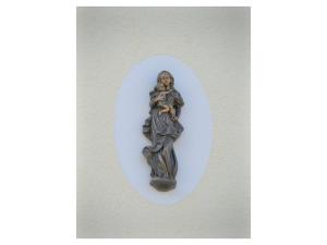 a statue of a woman holding a child on a wall at Ferienwohnung Haus Maria in Wäschenbeuren