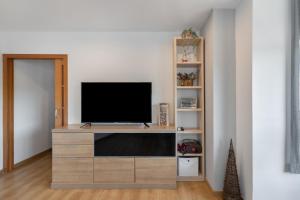 a living room with a television on a wooden entertainment center at Niu Turistic Olvan in Olvan