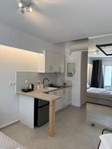 a kitchen with a sink and a table in a room at Nice & cosy central studios in Mikonos