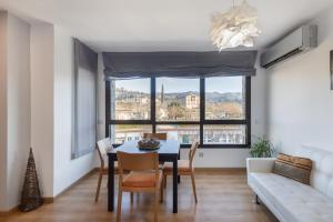 a dining room with a table and a couch at Niu Turistic Olvan in Olvan