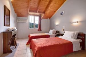 a hotel room with two beds and a window at Dolphin Apartment Sea View 9 in Keri