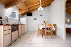 a kitchen with a table and a dining room at Dolphin Apartment Sea View 9 in Keri