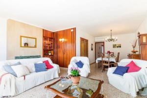a living room with two white couches and a table at Puig in Pollença +7 photos