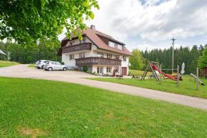 a house with a car parked next to a playground at Baschijörgenhof in Sankt Peter