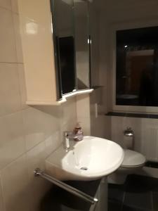 a bathroom with a white sink and a mirror at Bei Heike 1 in Zetel +19 photos