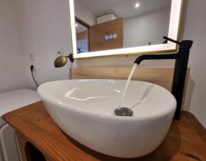 a bathroom with a white bowl sink on a wooden counter at L'Ecole Buissonnière de Mazalibrand in Mazet-Saint-Voy +13 photos