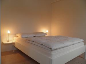 En eller flere senge i et værelse på Tversted Strandpark