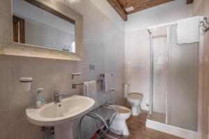 a bathroom with a sink and a toilet and a shower at Casale I Cascetti in Piancastagnaio +24 photos