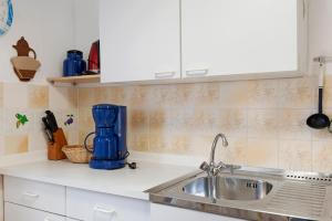 a kitchen with a sink and a blue appliance at Ferienbungalows Werner in Koserow +34 photos