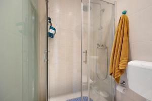 a bathroom with a shower with a glass door at The Studio - Pet friendly in Alvor +32 photos