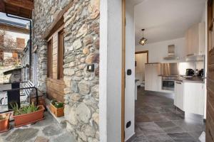 a stone wall in the kitchen of a house at Mini House Valle d'Aosta in Roisan