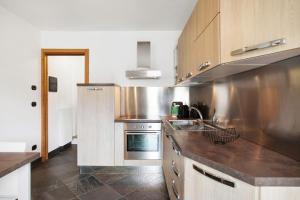a kitchen with a sink and a stove at Mini House Valle d'Aosta in Roisan +18 photos