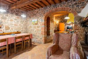 a kitchen with a table and a stone wall at Mulino di Beboli in Lamporecchio +16 photos