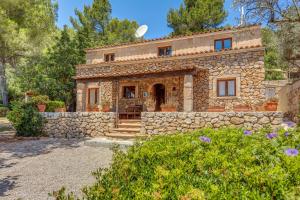a stone house with a stone wall at Son del Rio Vell in Pollença