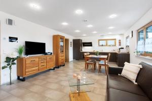 a living room with a couch and a dining room at Haus Morgensonne in Weilheim