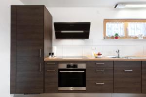 a kitchen with brown cabinets and a sink at Haus Morgensonne in Weilheim