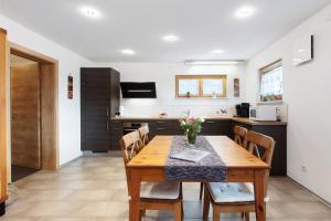 a kitchen and dining room with a wooden table and chairs at Haus Morgensonne in Weilheim
