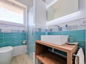 a bathroom with a sink and a toilet at Casa Diamante Blu Mare in Marina di Campo +36 photos