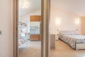a bedroom with a bed and a closet at Villa Gloma in Capoterra