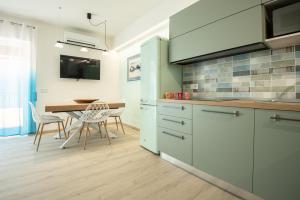 a kitchen with a table and a dining room at Casa Diamante Blu Mare in Marina di Campo