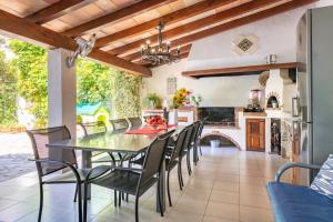 a kitchen and dining room with a table and chairs at Can Xeliu in Sóller