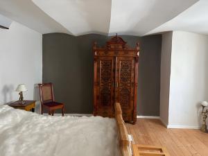a bedroom with a bed and a large wooden cabinet at Burghaus in Bad Driburg