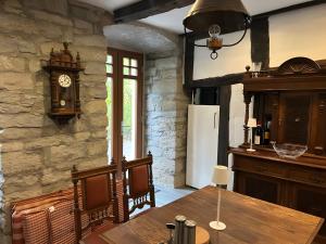 a kitchen with a table and a clock on the wall at Burghaus in Bad Driburg