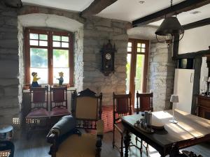 a living room with a table and chairs and a stone wall at Burghaus in Bad Driburg +11 photos