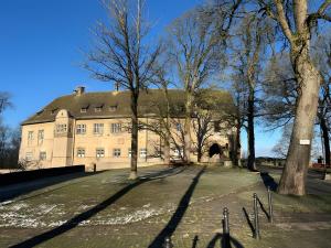 a large building with trees in front of it at Burghaus in Bad Driburg
