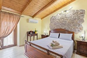 a bedroom with a bed with towels on it at Affittacamere Le Muse in Scano Montiferro