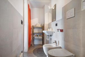 a bathroom with a white sink and a toilet at Nature House Custu Giancu in Cichero